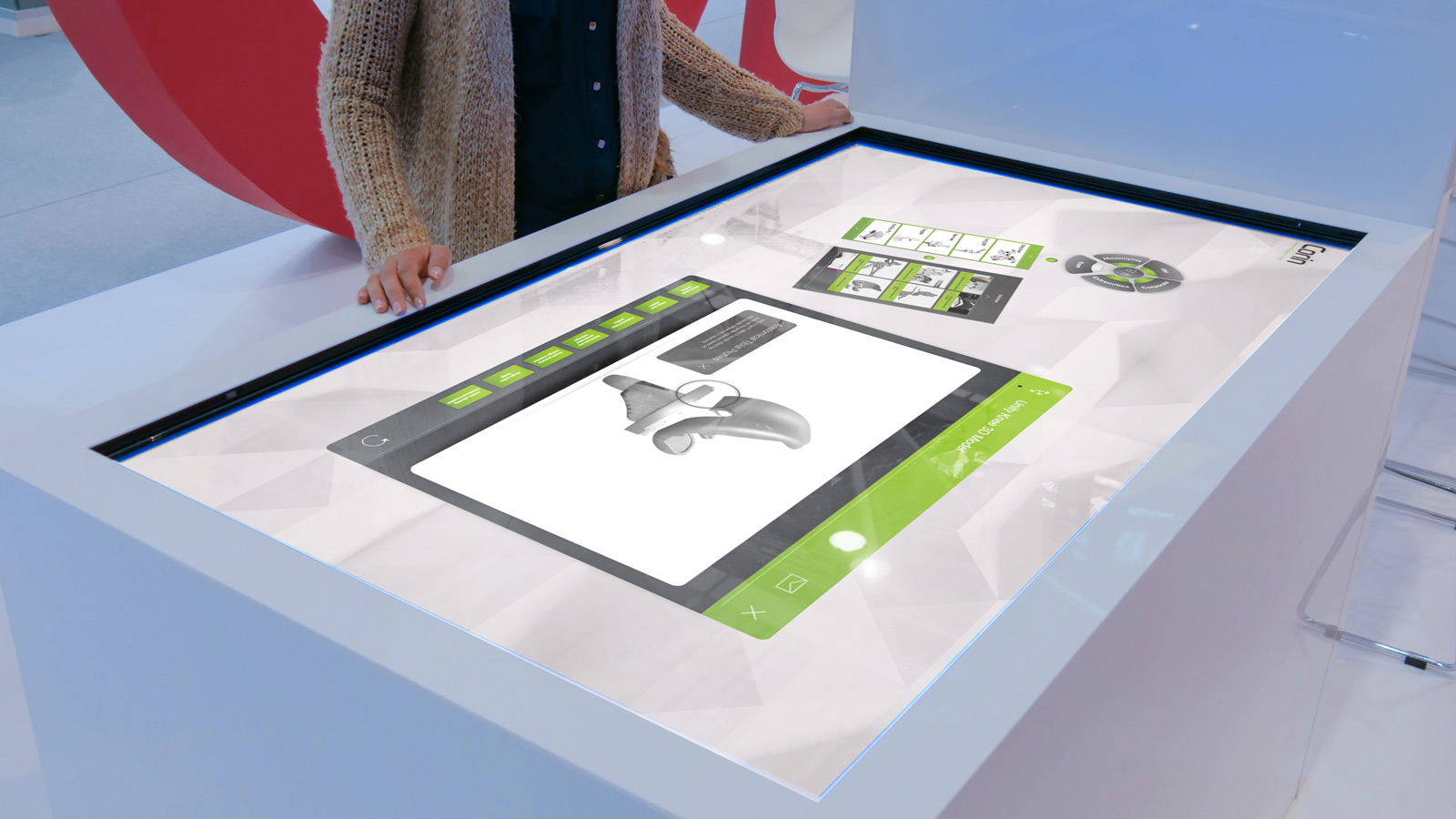 woman interacting with Corin interactive touchscreen software displayed on large white table