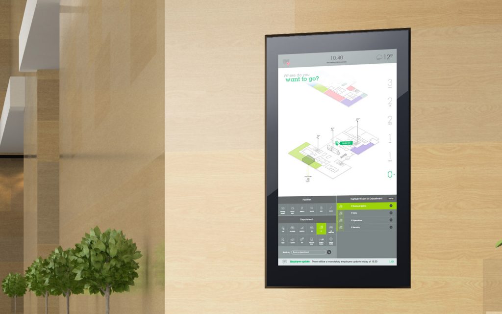 Interactive touchscreen software displayed on light beige wooden panel office wall