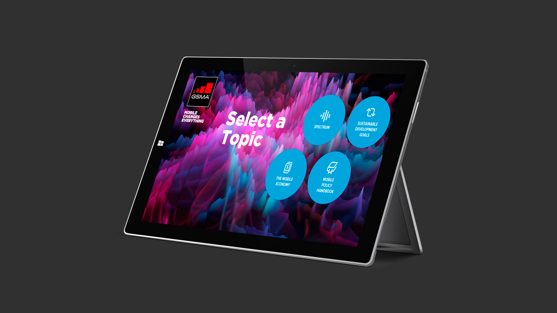 Black windows tablet displaying GSMA interactive touchscreen digital presentation