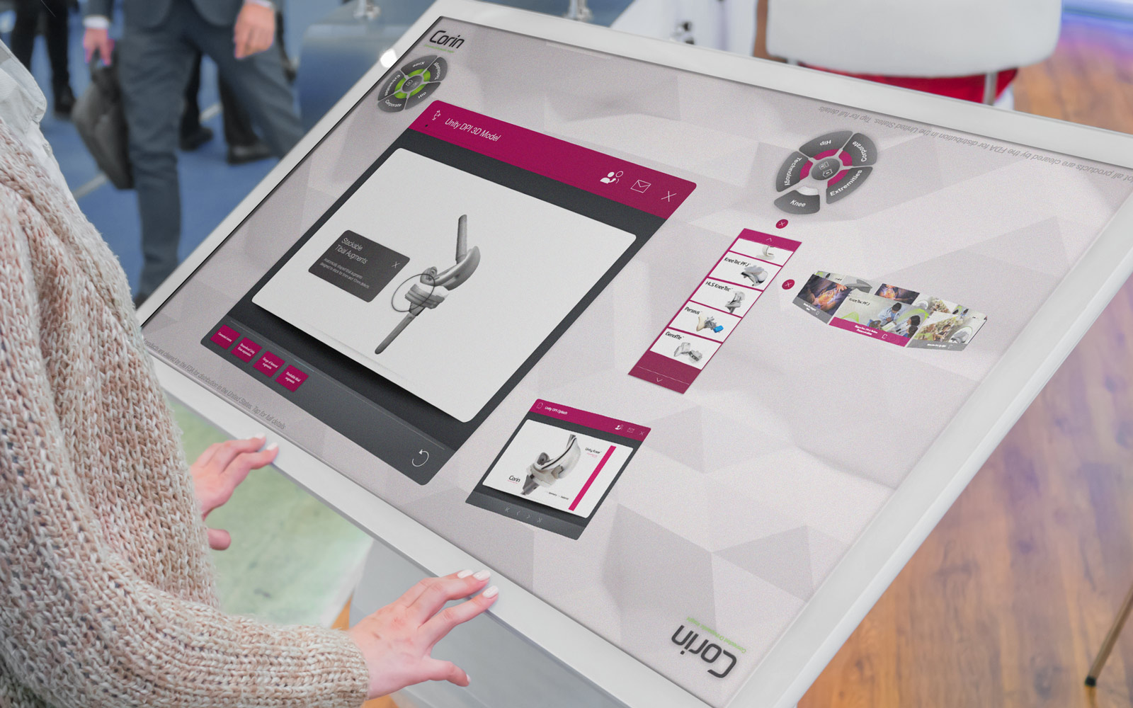 person interacting with Corin interactive touchscreen software displayed on large white tablet