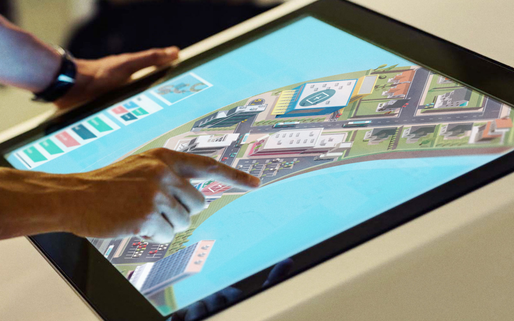 A user of a touchscreen experience exploring the cityscape designed for SCC. 