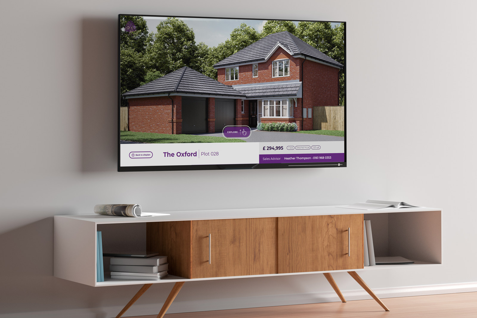 large black monitor displaying Laurus interactive presentation of house above white and wooden panelled cupboard