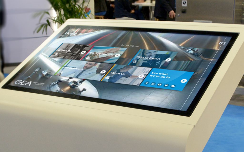large white monitor showing GEA interactive touchscreen presentation